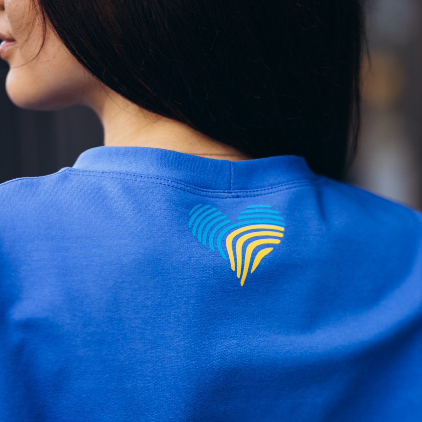 Woman in blue sports wear standing outside by the building